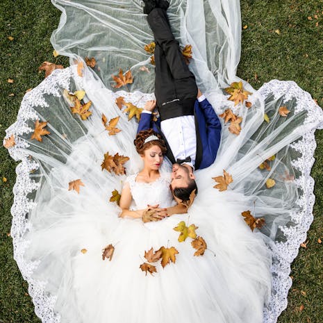 Aerial Photo of Man and Woman Lying on Grass Field